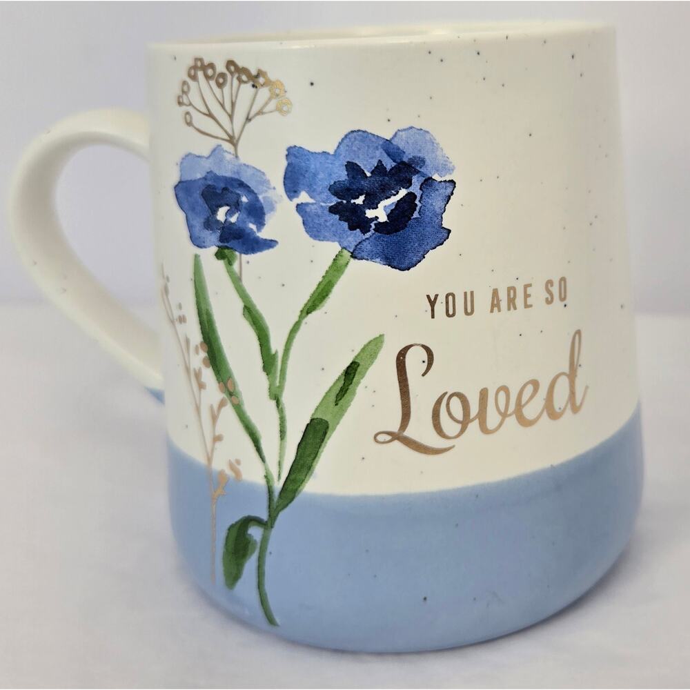 Decorative coffee mug, watercolor-style blue flowers, text "You Are So‎ Loved"